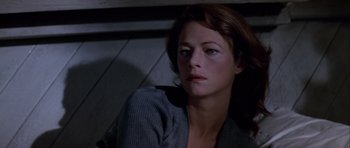 Movie still from “Orca” (1977), directed by Michael Anderson – A person sitting on a chair; Close Up shot, Low angle