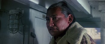 Movie still from “Orca” (1977), directed by Michael Anderson – An older man wearing a fur coat looking at the camera; Close Up shot, Low angle