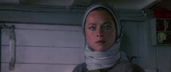 Movie still from “Orca” (1977), directed by Michael Anderson – A person wearing a head scarf; Close Up shot, Low angle