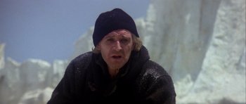 Movie still from “Orca” (1977), directed by Michael Anderson – A man in a black jacket and a black hat; Close Up shot, Low angle