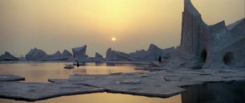 Movie still from “Orca” (1977), directed by Michael Anderson – A person standing on top of an ice floe in the ocean; Extreme Wide shot, High angle