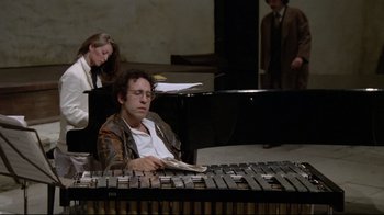 Movie still from “Orchestra Rehearsal” (1978), directed by Federico Fellini – A man sitting in front of a keyboard; Medium shot, High angle