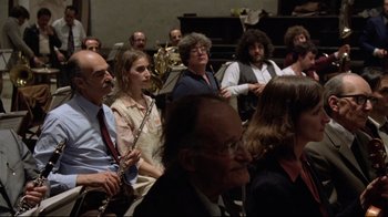 Movie still from “Orchestra Rehearsal” (1978), directed by Federico Fellini – A group of people sitting in front of an instrument; Medium shot, High angle
