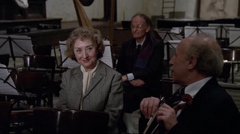 Movie still from “Orchestra Rehearsal” (1978), directed by Federico Fellini – A man and a woman are sitting at a piano; Medium shot, High angle