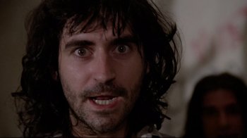 Movie still from “Orchestra Rehearsal” (1978), directed by Federico Fellini – A person with long black hair; Close Up shot, Low angle