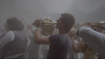 Movie still from “Orchestra Rehearsal” (1978), directed by Federico Fellini – A group of people standing in the fog playing instruments; Medium shot, Low angle