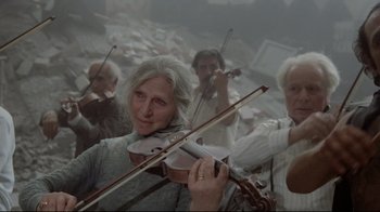 Movie still from “Orchestra Rehearsal” (1978), directed by Federico Fellini – A group of older people playing their instruments; Wide shot, Low angle