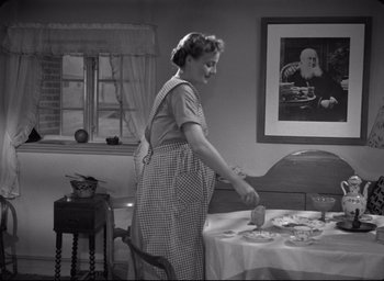 Movie still from “Ordet” (1955), directed by Carl Theodor Dreyer – An old photo of a woman preparing a meal; Medium shot, Low angle