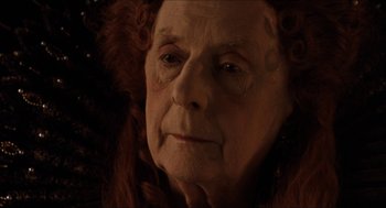 Movie still from “Orlando” (1992), directed by Sally Potter – An old woman with red curly hair and an older woman with white eyes; Close Up shot, High angle