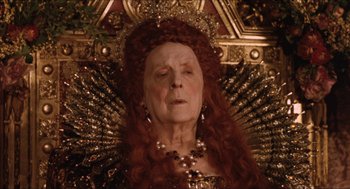 Movie still from “Orlando” (1992), directed by Sally Potter – An older woman with red hair wearing a crown; Close Up shot, Low angle