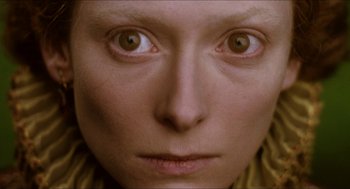 Movie still from “Orlando” (1992), directed by Sally Potter – A woman's face with brown eyes; Extreme Close Up shot, Overhead angle