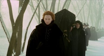 Movie still from “Orlando” (1992), directed by Sally Potter – A woman in a black dress and a man in a black coat; Medium shot, Over the shoulder angle
