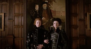 Movie still from “Orlando” (1992), directed by Sally Potter – Two women dressed in black standing in front of a painting; Medium shot, Low angle