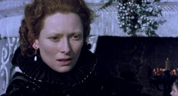Movie still from “Orlando” (1992), directed by Sally Potter – A person wearing a dress; Close Up shot, Over the shoulder angle