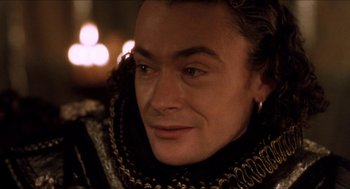 Movie still from “Orlando” (1992), directed by Sally Potter – A man's face in a medieval costume; Close Up shot, High angle