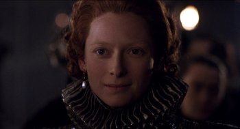 Movie still from “Orlando” (1992), directed by Sally Potter – A person wearing a necklace; Close Up shot, Over the shoulder angle