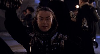 Movie still from “Orlando” (1992), directed by Sally Potter – A man in a black and silver outfit; Close Up shot, Low angle