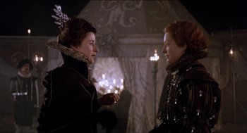 Movie still from “Orlando” (1992), directed by Sally Potter – Two women are standing in a room talking; Medium shot, Over the shoulder angle