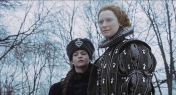 Movie still from “Orlando” (1992), directed by Sally Potter – Two women dressed in medieval clothing standing next to each other; Close Up shot, Low angle