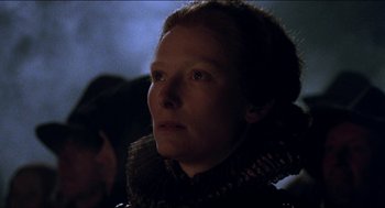 Movie still from “Orlando” (1992), directed by Sally Potter – A person wearing a dress; Close Up shot, Low angle