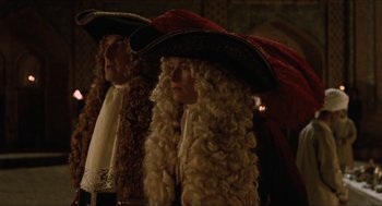 Movie still from “Orlando” (1992), directed by Sally Potter – Two people with long blonde hair and a red hat; Medium shot, Over the shoulder angle