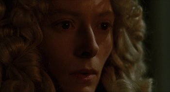 Movie still from “Orlando” (1992), directed by Sally Potter – A person's face in the dark; Extreme Close Up shot, Low angle