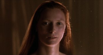 Movie still from “Orlando” (1992), directed by Sally Potter – A person with long red hair; Close Up shot, Low angle