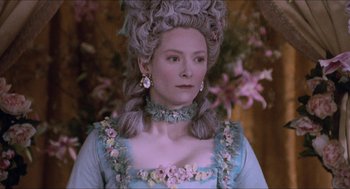 Movie still from “Orlando” (1992), directed by Sally Potter – A woman in a blue dress with flowers in her hair; Close Up shot, Over the shoulder angle