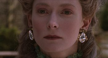 Movie still from “Orlando” (1992), directed by Sally Potter – A person wearing a pair of earrings; Close Up shot, Over the shoulder angle