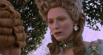 Movie still from “Orlando” (1992), directed by Sally Potter – A person wearing a wig; Close Up shot, Over the shoulder angle