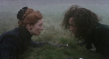 Movie still from “Orlando” (1992), directed by Sally Potter – Two people are laying in the grass looking at each other; Medium shot, High angle