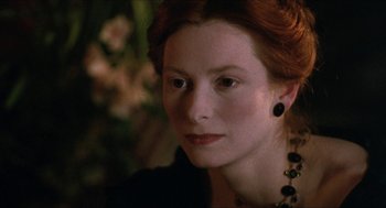 Movie still from “Orlando” (1992), directed by Sally Potter – A person wearing a necklace; Close Up shot, Over the shoulder angle