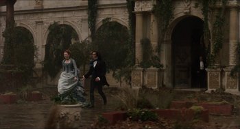 Movie still from “Orlando” (1992), directed by Sally Potter – A man and a woman are running in the rain; Wide shot, High angle