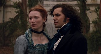 Movie still from “Orlando” (1992), directed by Sally Potter – A man and a woman standing next to each other in front of a fountain; Close Up shot, Over the shoulder angle
