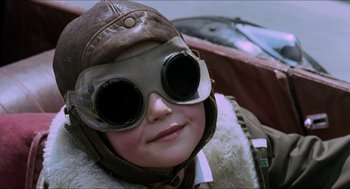 Movie still from “Orlando” (1992), directed by Sally Potter – A young boy wearing a pilot's outfit and goggles; Close Up shot, Low angle