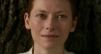 Movie still from “Orlando” (1992), directed by Sally Potter – A woman's face with green eyes; Close Up shot, Over the shoulder angle