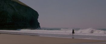 Movie still from “Oscar and Lucinda” (1997), directed by Gillian Armstrong – A person on a surfboard in the ocean; Extreme Wide shot, High angle