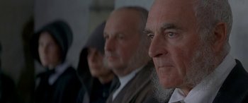 Movie still from “Oscar and Lucinda” (1997), directed by Gillian Armstrong – A group of people sitting next to each other in a room; Close Up shot, Over the shoulder angle