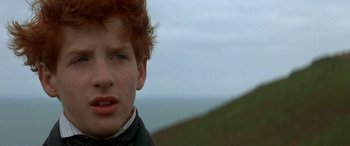Movie still from “Oscar and Lucinda” (1997), directed by Gillian Armstrong – A young man's face with a mountain in the background; Close Up shot, Low angle