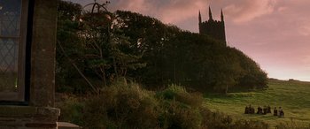 Movie still from “Oscar and Lucinda” (1997), directed by Gillian Armstrong – A view of trees and a castle in the background; Extreme Wide shot, Low angle