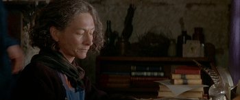 Movie still from “Oscar and Lucinda” (1997), directed by Gillian Armstrong – An older woman sitting in front of a stack of books; Close Up shot, Low angle