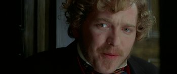 Movie still from “Oscar and Lucinda” (1997), directed by Gillian Armstrong – A person with curly hair; Close Up shot, Over the shoulder angle