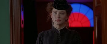 Movie still from “Oscar and Lucinda” (1997), directed by Gillian Armstrong – A woman in a black dress and a black hat; Close Up shot, Low angle