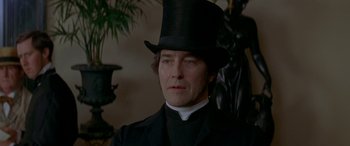 Movie still from “Oscar and Lucinda” (1997), directed by Gillian Armstrong – A person wearing a top hat; Close Up shot, Low angle