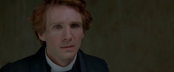 Movie still from “Oscar and Lucinda” (1997), directed by Gillian Armstrong – A person wearing a suit and tie; Close Up shot, Over the shoulder angle