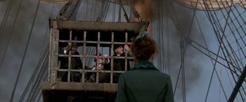 Movie still from “Oscar and Lucinda” (1997), directed by Gillian Armstrong – A group of people sitting in a cage on top of a ship; Wide shot, Low angle