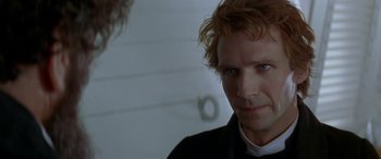 Movie still from “Oscar and Lucinda” (1997), directed by Gillian Armstrong – A person wearing a suit and tie; Close Up shot, Over the shoulder angle