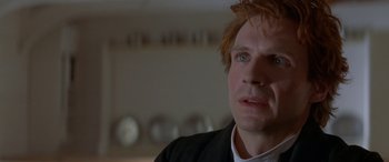 Movie still from “Oscar and Lucinda” (1997), directed by Gillian Armstrong – A person in a room with plates on the wall; Close Up shot, Low angle