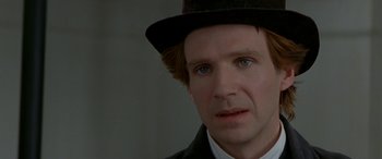 Movie still from “Oscar and Lucinda” (1997), directed by Gillian Armstrong – A person wearing a suit and a hat; Close Up shot, Over the shoulder angle