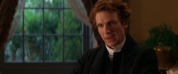 Movie still from “Oscar and Lucinda” (1997), directed by Gillian Armstrong – A person wearing a suit and tie; Close Up shot, Over the shoulder angle